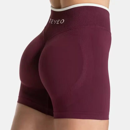 Short de sport femme TEVEO – Taille haute gainante, coupe sans couture, tissu sculptant pour sublimer les hanches. Parfait pour le fitness, le yoga, le running ou la salle de sport